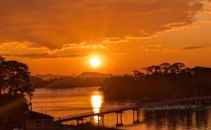 a sunset over a river with a bridge at ウェルカムイン松島 in Matsushima +3 photos