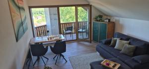 a living room with a couch and a table at Haus Neubauer in Giengen an der Brenz +4 photos