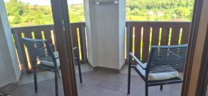 two chairs sitting on a balcony with a view at Haus Neubauer in Giengen an der Brenz