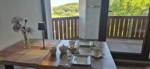 a dining room table with a view of a balcony at Haus Neubauer in Giengen an der Brenz