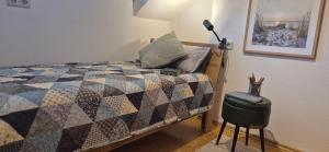a bedroom with a bed with a quilt and a lamp at Haus Neubauer in Giengen an der Brenz