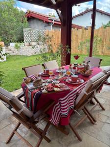 a table with a red and white striped table cloth at Villa Les Hortensias B&B in Arcangues