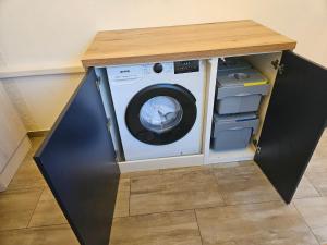 a washer and dryer with a wooden counter top at Apartment MAIO in Viskovo