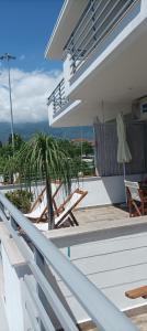a balcony of a house with lounge chairs and a view of the ocean at Boutique Pelayo in Leptokarya