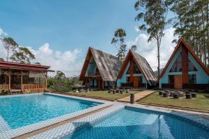 a house with a swimming pool in front of it at The Cabin Artana By ARBA in Palayangan