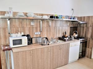 a kitchen with a microwave and a sink at Dózsaház in Zalaegerszeg