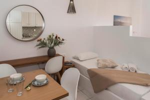 a living room with a table and a mirror at Galini in Agia Irini Milos
