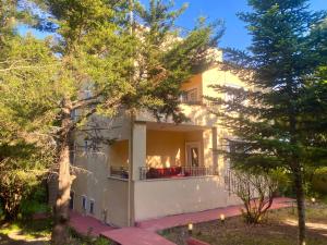 a large white building with trees in front of it at Nature Gate Airport Hotel in Arnavutköy