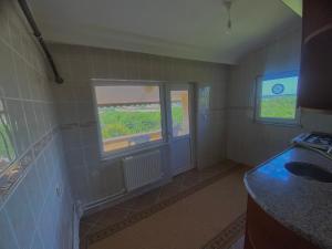 a bathroom with a sink and a window at Nature Gate Airport Hotel in Arnavutköy