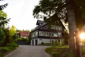 a large black and white house with a driveway at Willa Cieszynianka in Wisła