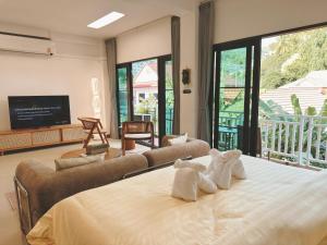 a bedroom with a bed with two stuffed animals on it at Mr Oh in Phuket Karon in Ka Rorn +51 photos
