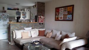 a living room with a couch and a glass table at Apartment Face Aux Pistes in Gréolières les Neiges