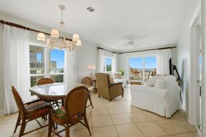 a living room with a table and a couch at Riviera Dunes 201 in Perdido Key