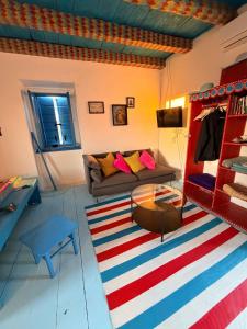 a living room with a couch and a colorful rug at Dalmatian rustic house in Petrcane +64 photos