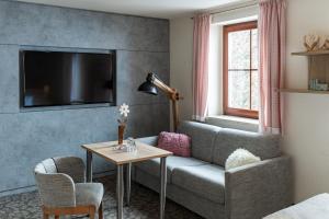 a living room with a couch and a table at Hotel in der Mühle in Werdau