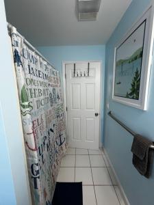 a bathroom with blue walls and a white door at Dockside Dreamz 2 with beach & dock in Clarksville +25 photos