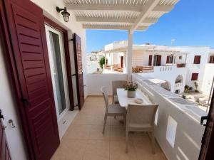 a balcony with a table and chairs and a view at Naxos Mare in Agia Anna Naxos