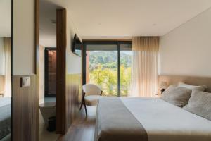a hotel room with a bed and a window at Souto Village - Douro Verde - by FERO in Maureles +102 photos
