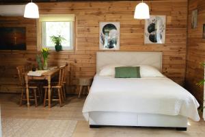 a bedroom with a bed and a table and a dining room at Domek U Stefanów - Królowy Most in Królowy Most