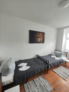 a room with two beds and a lion picture on the wall at Revant Monteurzimmer Haus WE 3 in Arnstadt