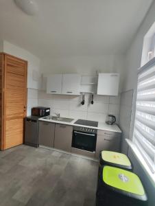 a small kitchen with a sink and a stove at Revant Monteurzimmer Haus WE 3 in Arnstadt +10 photos