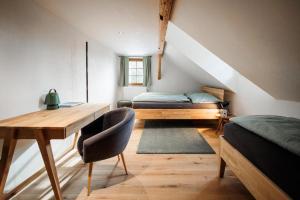 a bedroom with a desk and a bed and a table at Chalupa Mariánská hora 776 in Jablonec nad Nisou