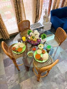 a glass table with plates of food on it at Clean Culture Retreat in Mysore