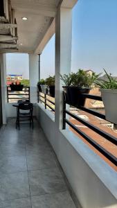ein Balkon mit einem Tisch und Topfpflanzen darauf in der Unterkunft Empire M in Kinshasa