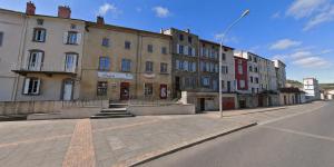 an empty street with buildings on the side of the road at Le refuge médiéval - Appartement climatisé perché sous les toits de Billom in Billom