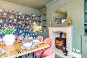 a dining room with a fireplace and a christmas tree at The Haven, Leyburn in Leyburn
