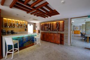 a wine tasting room with a bar with white chairs at Marisol Boutique Hotel in Gundogan