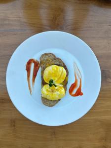 a white plate with a sandwich with eggs and bacon at Homestay IDR Bali in Jimbaran +12 photos