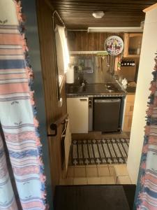 a kitchen with a sink and a stove at Egen stuga med delat badrum in Norrtälje +21 photos