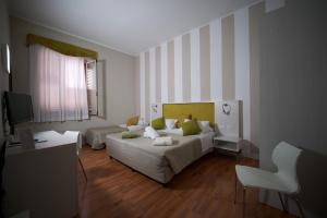 a living room with a bed and a couch at Hotel Sant'Elia in Messina