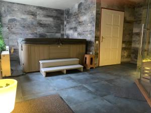 a large room with a couch and a stage at Várfal Panzió és Wellness in Pécs
