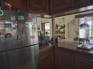 a kitchen with a stainless steel refrigerator with magnets at Yaubula Bed and Breakfast Homestay in Nadi