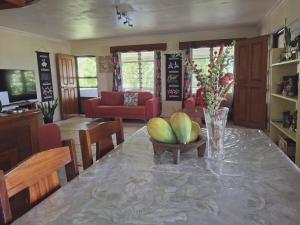 a kitchen with a table with a bowl of fruit on it at Yaubula Bed and Breakfast Homestay in Nadi