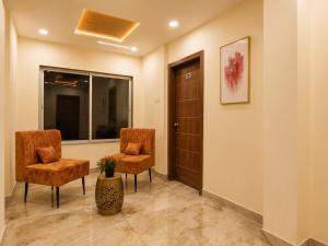 a waiting room with two chairs and a door at Hotel Shiv Shakti in Rajkot +24 photos