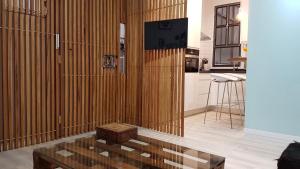 a living room with a tv and a wooden wall at Apartamento Salamanca in Madrid