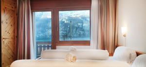 a bedroom with two beds and a large window at Hotel Schiffahrt in Mols +59 photos