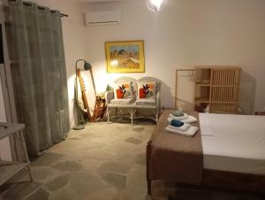 a living room with two chairs and a bed at Blue Agave in Agios Sostis