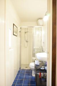 a bathroom with a shower and a toilet and a sink at Zannoni Apartment in Florence