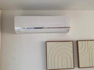 a white heater on a wall with two pictures at Verliefd in Brustem in Sint-Truiden +22 photos