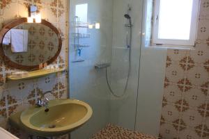 La salle de bains est pourvue d'une douche, d'un lavabo et d'un miroir. dans l'établissement Ferienhaus Feichtinger, à Obertiefenbach