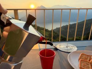 a person is pouring syrup onto a plate of food at Lake Iseo View Retreat - Quiet & Nature in Fonteno