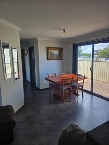 a dining room with a wooden table and chairs at Wudinna Crow's Nest in Wudinna +10 photos
