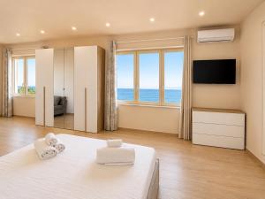 a bedroom with a bed and a large window at AWA Kafara in Porticello