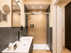 a bathroom with a shower and a white sink at AWA Kafara in Porticello