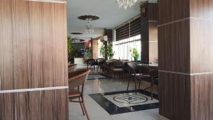 a restaurant with a bar with chairs and tables at modern sity hotel in Erbil