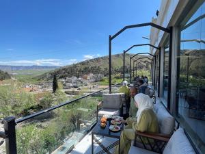 a group of people sitting on a balcony with a view at modern sity hotel in Erbil